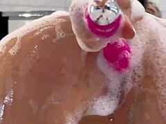 مونيكا فوكس تلعب بلعبة وردية في حمام رغوي.
