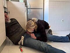 Amateur blonde MILF gives a handsjob to the plumber in the kitchen
