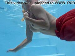 Blonde milf met natuurlijke borsten pronkt met haar lichaam in het zwembad