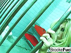 Brooke Brand gets naked in jail and pleasures herself with her big tits